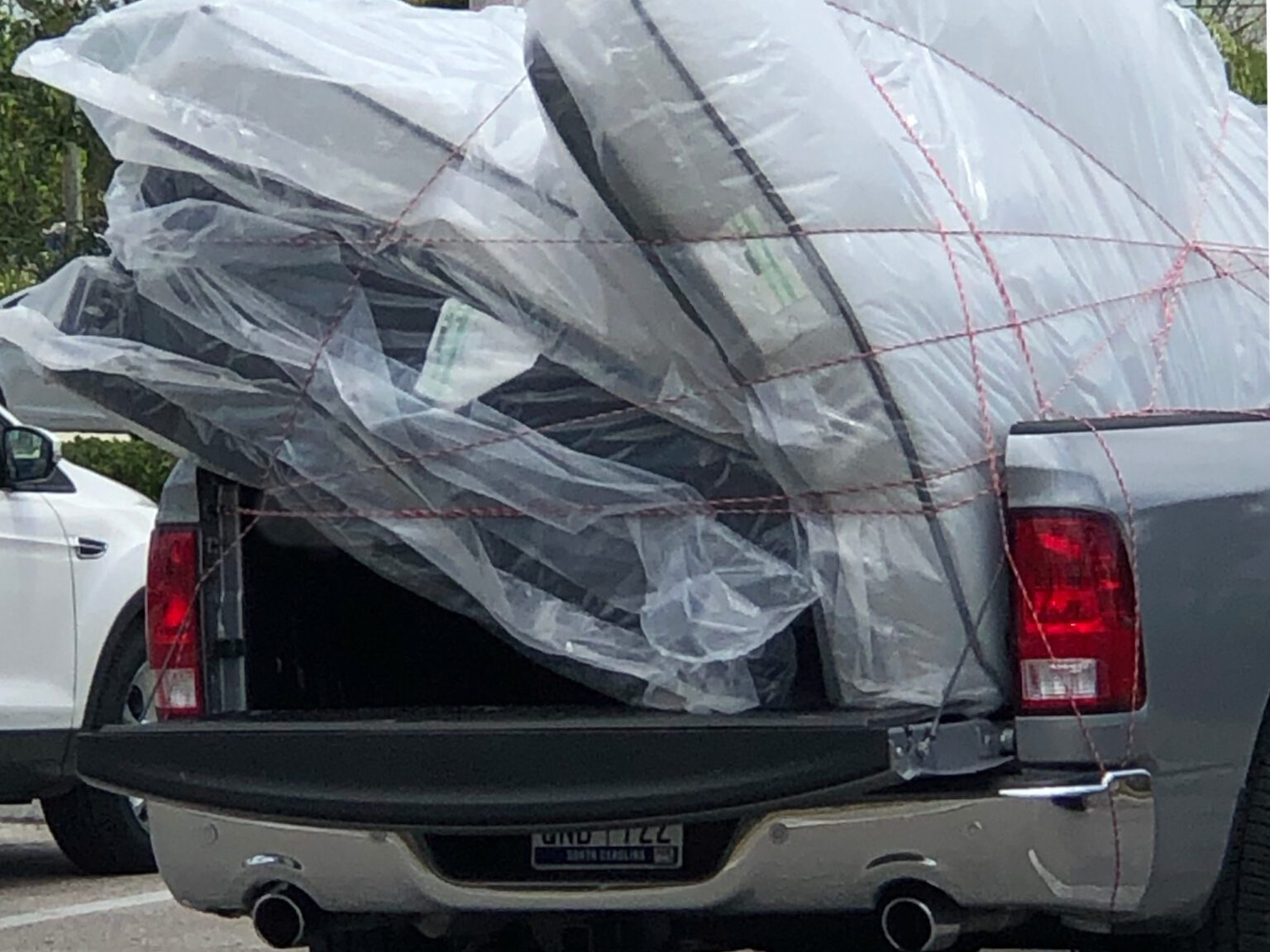 The back of a pickup truck with a mattress in it, showcasing the convenience and practicality of buying with Mike McCatty Group.