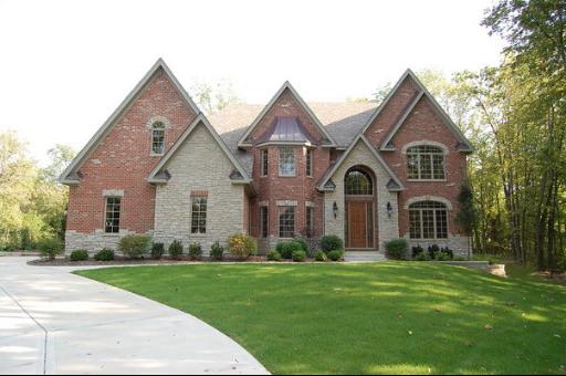 A large brick home with a driveway.