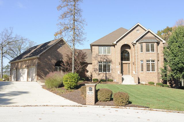 A large brick house with a driveway.
